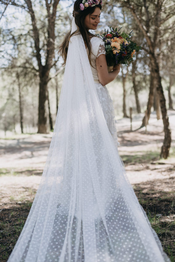 Bride wearing a flower crown with a polka dot bridal veil